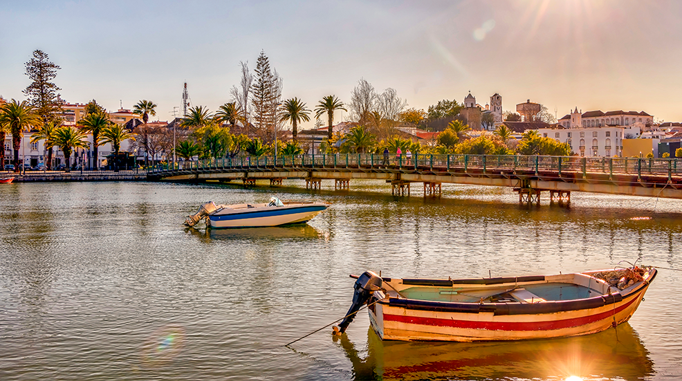 Sunlight glistening on the water as boats bob in the Algarve, Portugal